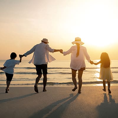 A family on the beach representing High Net Worth Wealth Management.